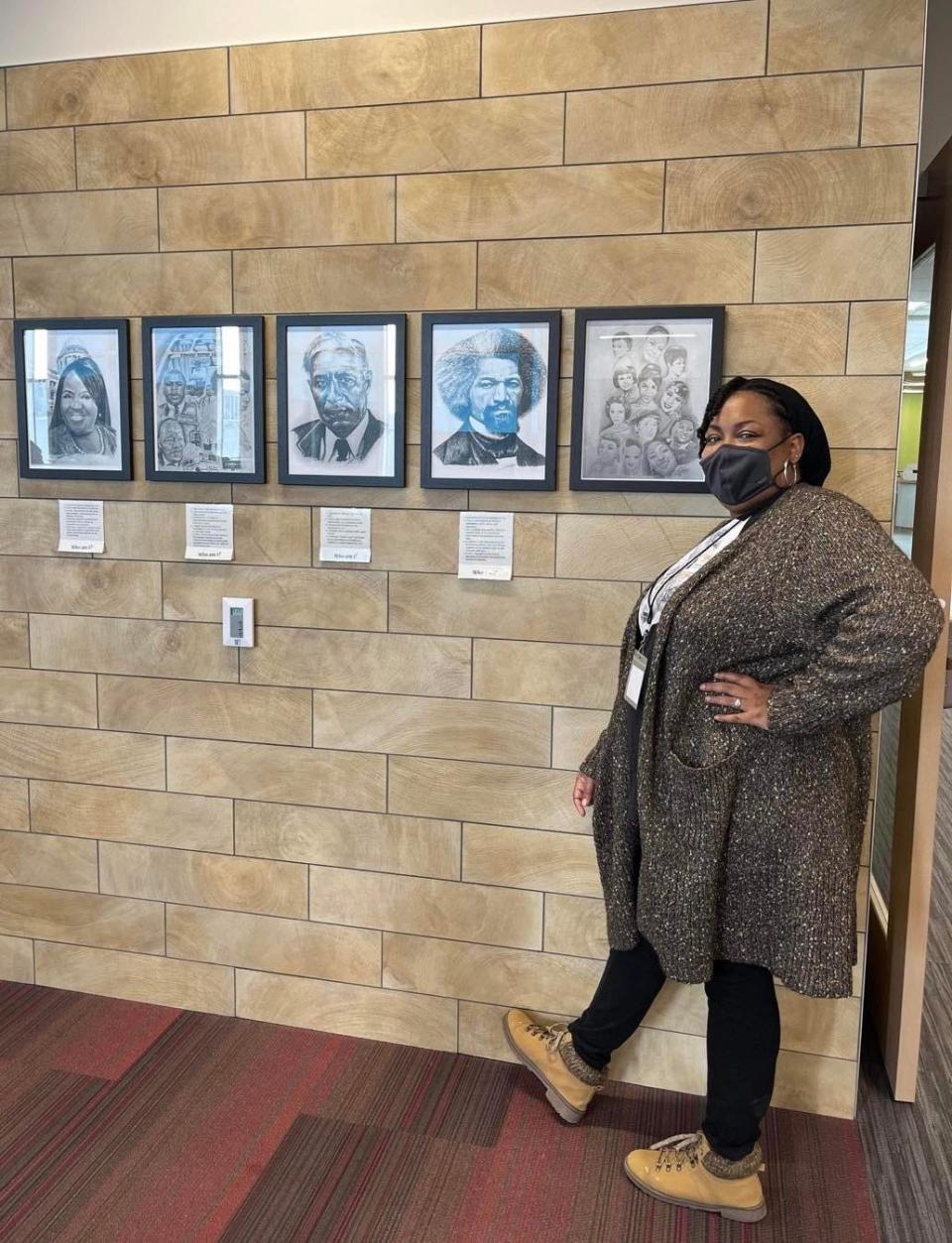 Deseré Mayo is shown with artwork she created. The McKinley High School graduate is displaying her drawings at Malone University in the new exhibit, "Black Lives Belong: Power Through the Decades."