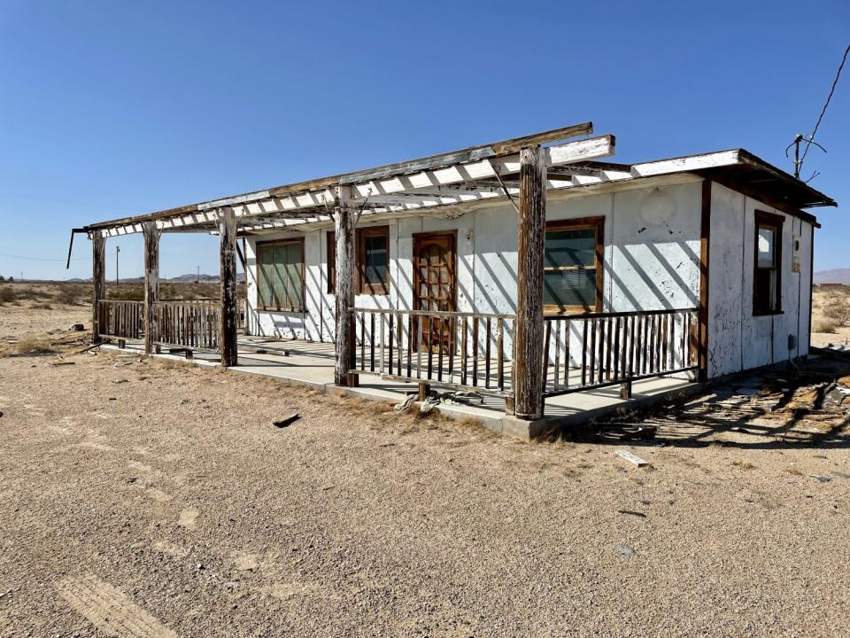 A small house sitting on dirt.