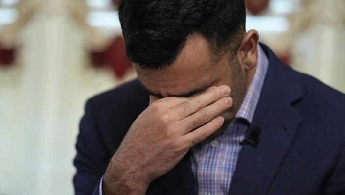 Sami-ullah Safi becomes emotional as he talks about his brother's journey to the U.S. during an interview Wednesday, Jan. 18, 2023, in Houston. Safi's brother, Abdul Wasi Safi, was an intelligence officer with the Afghan National Security Forces, providing U.S. armed forces with information for operations against terrorists, said Sami-ullah Safi. Wasi, as he is called by his family, was arrested after crossing the U.S.-Mexico border near Eagle Pass, Texas in September 2022, and charged with a federal misdemeanor related to wrongly entering the country and placed in a detention center in Central Texas. (AP Photo/David J. Phillip)