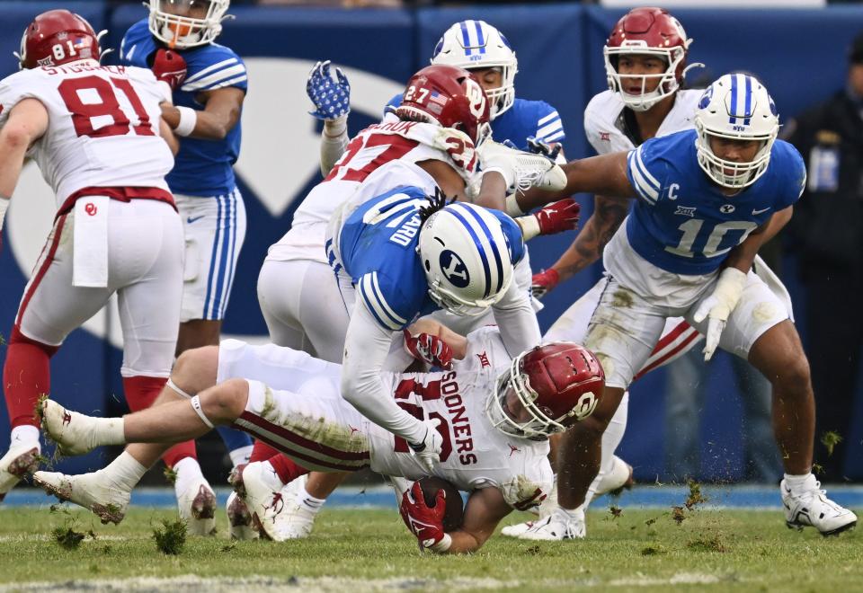 Brigham Young Cougars cornerback Eddie Heckard (5) hits Oklahoma Sooners wide receiver Drake Stoops (12) as BYU and Oklahoma play at LaVell Edwards Stadium in Provo on Saturday, Nov. 18, 2023. | Scott G Winterton, Deseret News