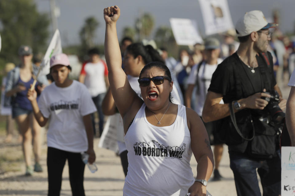 Diane Landers chants during a march along a levee toward the Rio Grande to oppose the wall the Trump administration wants to build on the river separating Texas and Mexico, Aug. 12, 2017, in Mission, Texas. (Photo: Eric Gay/AP)