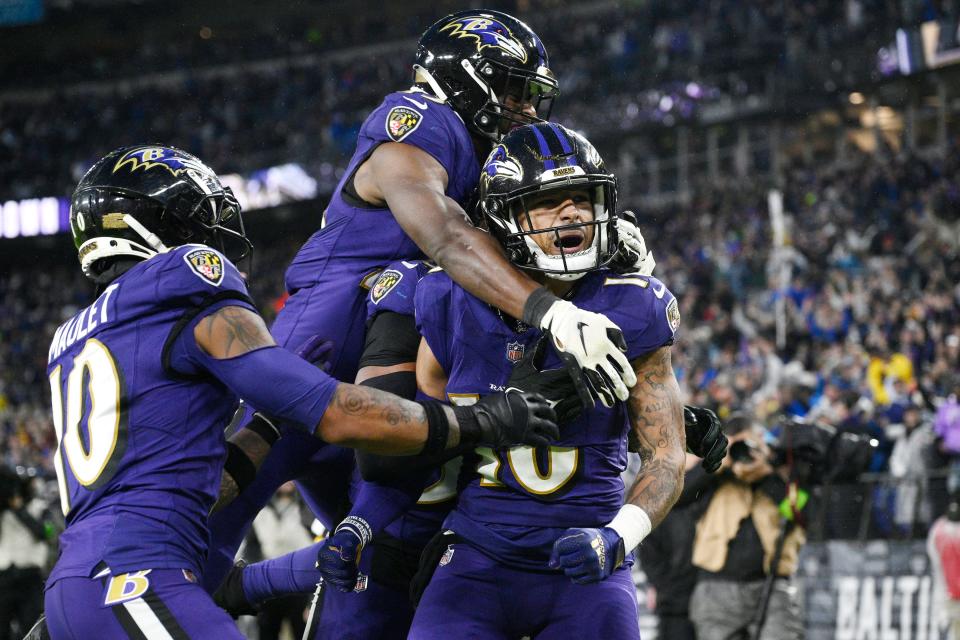 Baltimore Ravens punt returner Tylan Wallace, right, celebrates with teammates after a punt return for a touchdown against the Los Angeles Rams during overtime of an NFL football game Sunday, Dec. 10, 2023, in Baltimore.