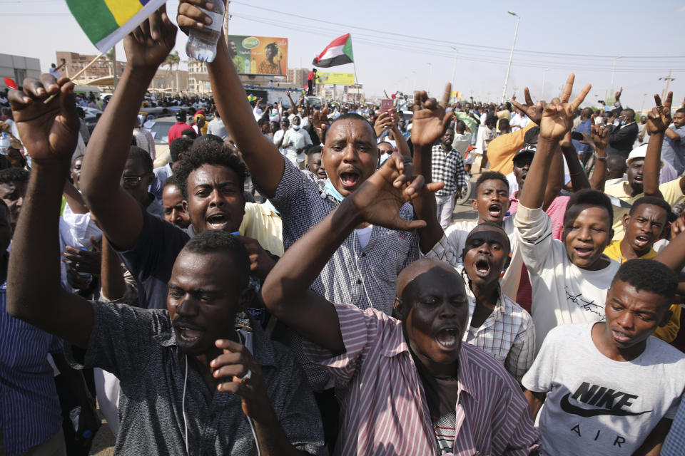 Sudanese demonstrators take to the streets of the capital Khartoum to demand the government's transition to civilian rule in Khartoum, Sudan, Thursday, Oct. 21, 2021. The relationship between military generals and Sudanese pro-democracy groups has deteriorated in recent weeks over the country's future. (AP Photo/Marwan Ali)