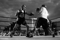 <p>Port Authority Police officers Jin Ha and Adam Pollack settle a dispute in the ring during a grudge match at the Brooklyn Smoker in the parking lot of Gargiulo’s Italian restaurant in Coney Island, Brooklyn, on Aug. 24, 2017. (Photo: Gordon Donovan/Yahoo News) </p>