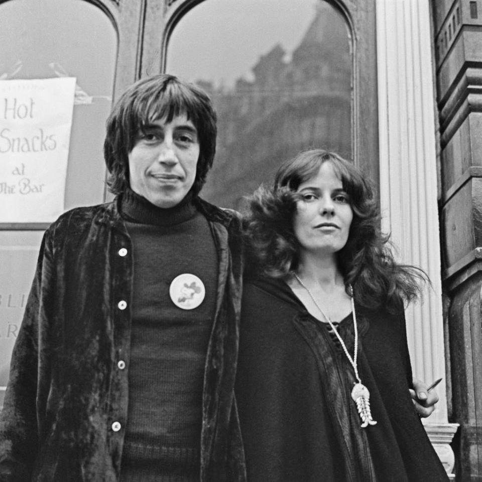 a hippie man and woman pose for a photo