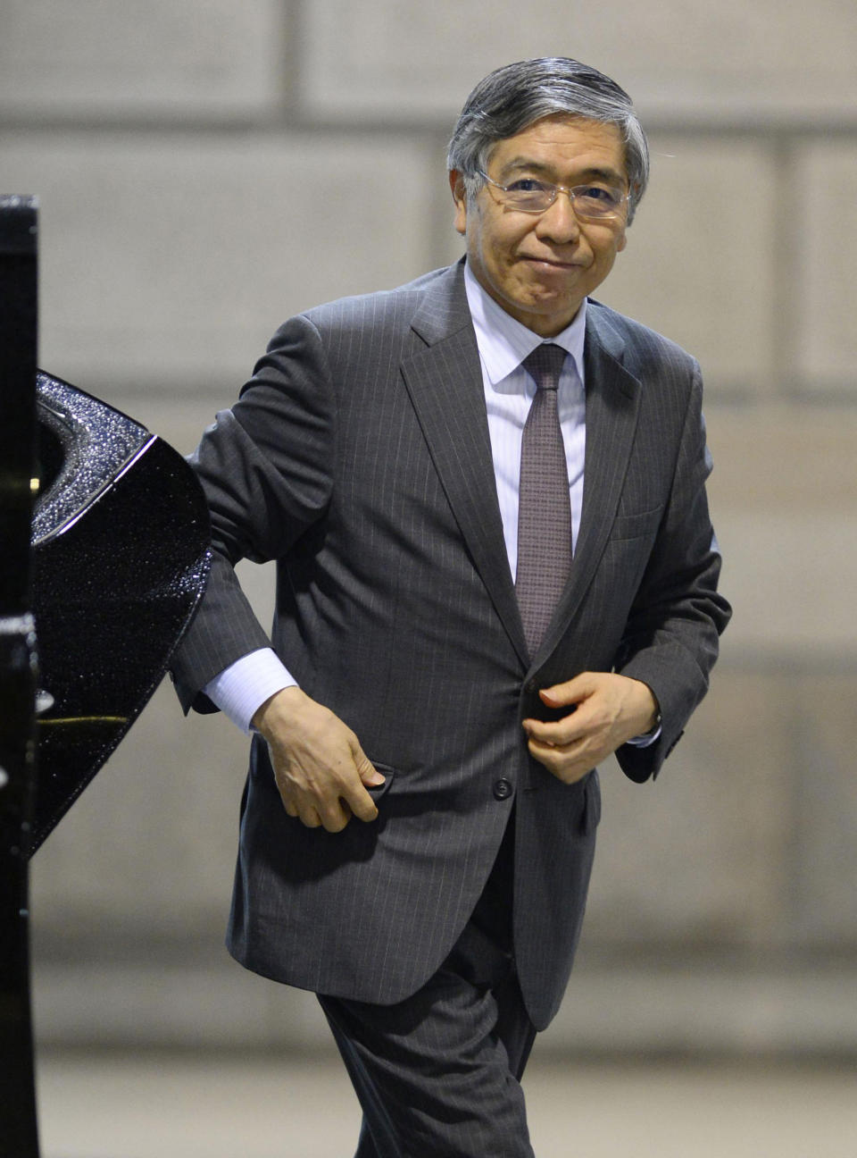 Bank of Japan Gov. Haruhiko Kuroda heads to a meeting at the headquarters of Bank of Japan in Tokyo, Wednesday, April 30, 2014. Japan's central bank was meeting Wednesday to assess the status of the country's economic recovery, as monthly data showed industrial output and wage growth falling short of expectations. (AP Photo/Kyodo News) JAPAN OUT, MANDATORY CREDIT