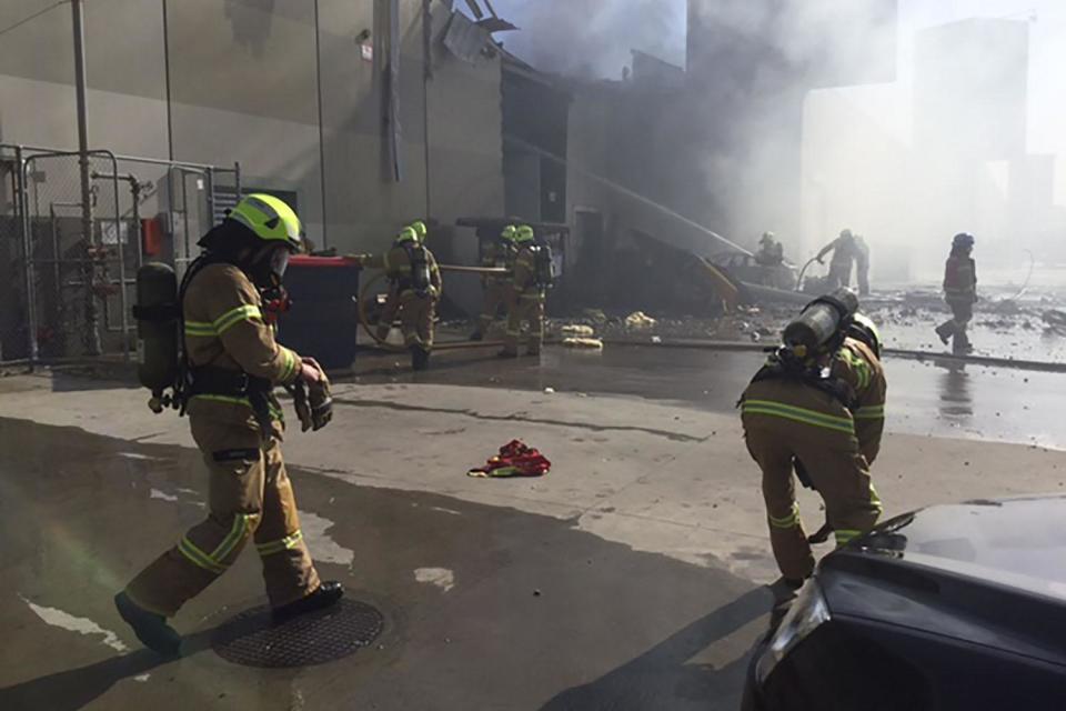 Fatal crash: Fire crews battle to extinguish flames a light aircraft exploded as it hit a shopping centre in Melbourne: AFP/Getty Images