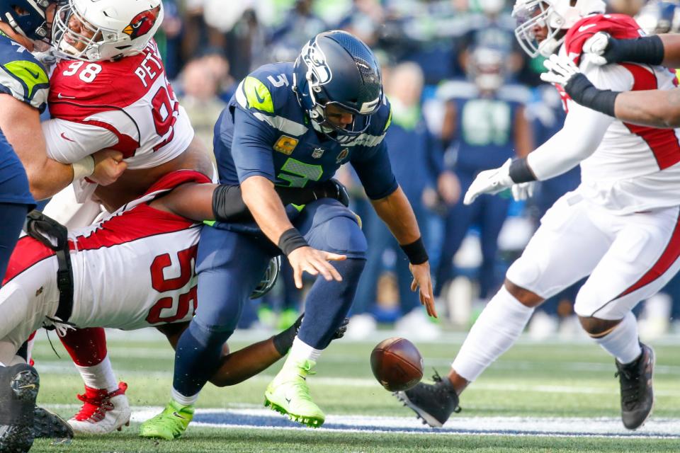 Nov 21, 2021; Seattle, Washington, USA; Arizona Cardinals outside linebacker Chandler Jones (55) forces a fumble by Seattle Seahawks quarterback Russell Wilson (3) during the first quarter at Lumen Field. Wilson recovered the football on the play. Mandatory Credit: Joe Nicholson-USA TODAY Sports