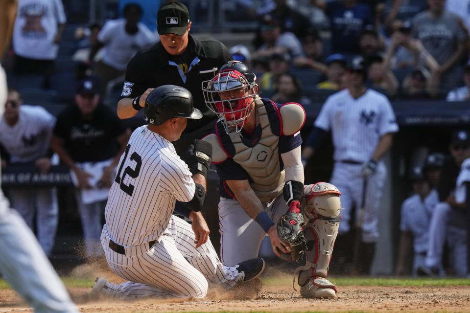 Boston Red Sox catcher Reese McGuire, front right, tags New York Yankees' Isiah Kiner-Falefa (12) during the eighth inning of a baseball game Sunday, Aug. 20, 2023, in New York. After a review, Kiner-Falefa was determined to be out on the play. (AP Photo/Frank Franklin II)