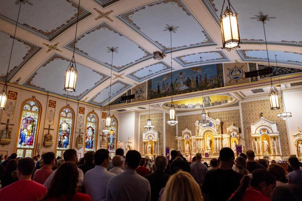 Hundreds of congregants stand during the Ash Wednesday service at Gesù Church in downtown Miami.