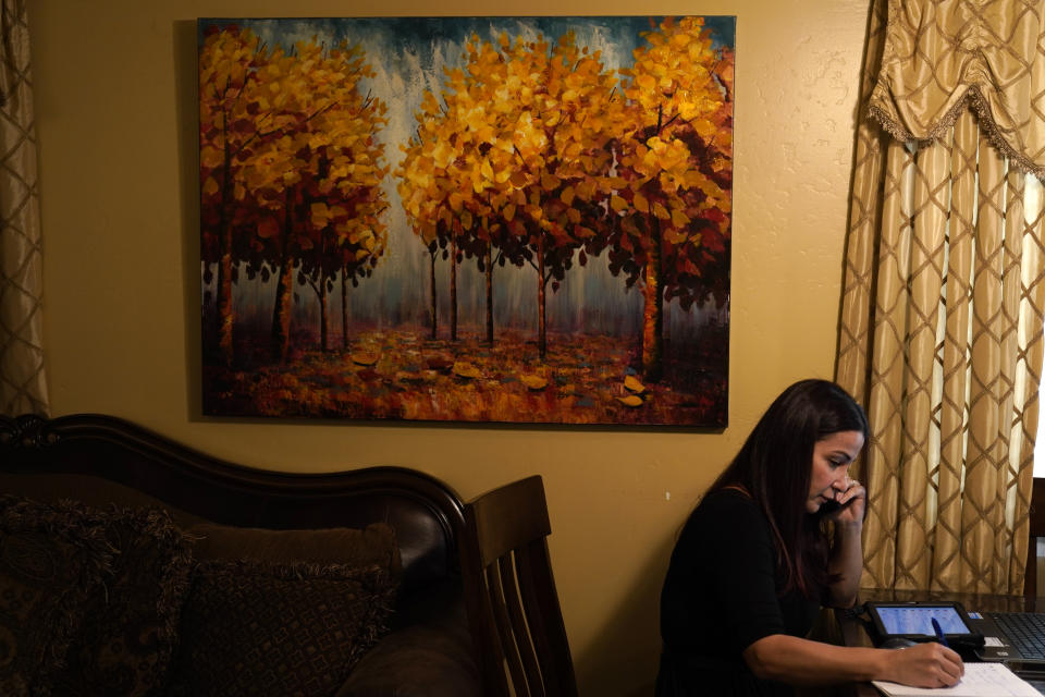 Iraqi immigrant Ethar Kakoz, a contact tracer for the COVID-19 virus, makes calls Wednesday, Oct. 28, 2020, in El Cajon, Calif. Kakoz is among a growing legion of ethnically and racially diverse contact tracers hired by local health departments to bridge the cultural divide in the United States and rebuild public confidence in America's public health system. (AP Photo/Gregory Bull)