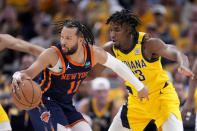 New York Knicks guard Jalen Brunson (11) drives around Indiana Pacers forward Aaron Nesmith (23) during the second half of Game 4 in an NBA basketball second-round playoff series, Sunday, May 12, 2024, in Indianapolis. (AP Photo/Michael Conroy)