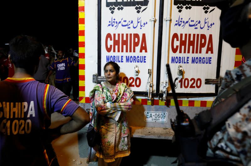 Relative of a victim mourns outside hospital morgue after a passenger plane crashed in a residential area near an airport in Karachi