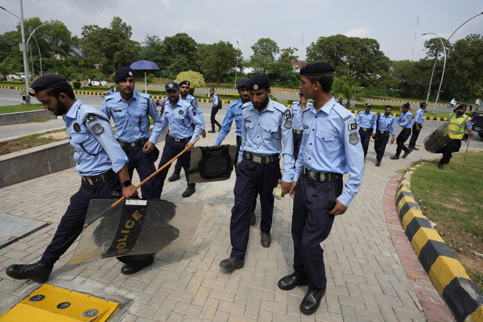 Police officers arrive to ensure security at the Islamabad High Court in Islamabad, Pakistan, Thursday, Aug. 24, 2023. A court in Pakistan's capital is likely to issue a crucial ruling Thursday on an appeal from the country's imprisoned former Prime Minister Imran Khan against his recent conviction and three-year sentence in a graft case, one of his lawyers said. (AP Photo/Anjum Naveed)