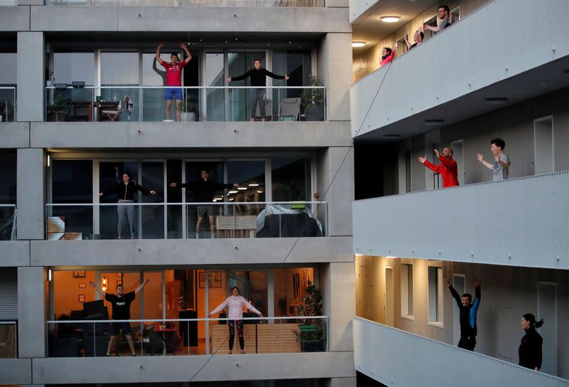 Residents exercise on their balconies following fitness trainers in Nantes