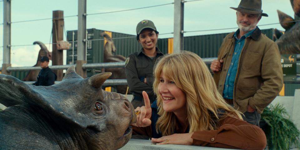 Ellie Sattler (Laura Dern, center) checks out a baby Nasutoceratops as Alan Grant (Sam Neill) looks on in "Jurassic World Dominion."