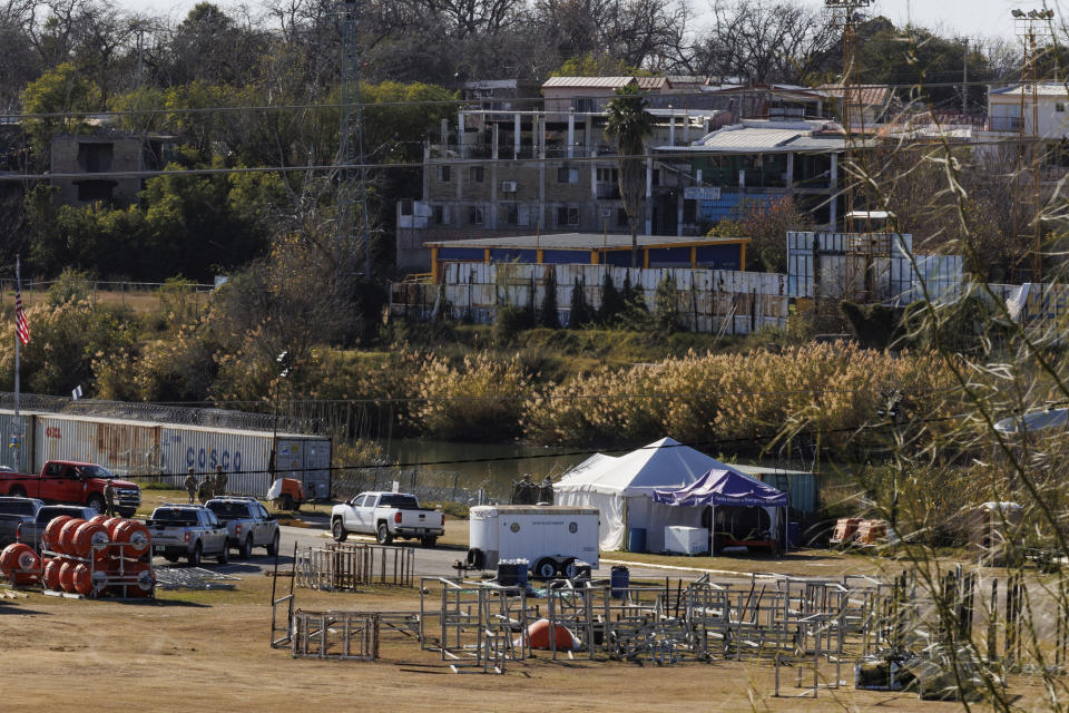 Texas Department of Public Safety officers work inside a fenced off Shelby Park, Thursday, Jan. 11, 2024, in Eagle Pass, Texas. The Justice Department on Friday, Jan. 12, asked the Supreme Court to order Texas to stop blocking Border Patrol agents from a portion of the U.S.-Mexico border where large numbers of migrants have crossed in recent months, setting up another showdown between Republican Gov. Greg Abbott and the Biden administration over immigration enforcement. (Sam Owens /The San Antonio Express-News via AP)