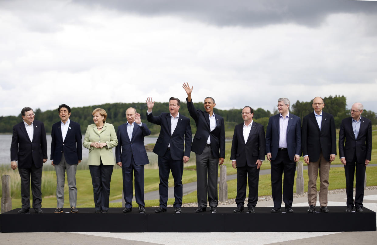 FILE - G8 leaders from left, European Commission President Jose Manuel Barroso, Japan's Prime Minister Shinzo Abe, German Chancellor Angela Merkel, Russian President Vladimir Putin, British Prime Minister David Cameron, US President Barack Obama, French President Francois Hollande, Canadian Prime Minister Stephen Harper, Italian Prime Minister Enrico Letta and European Council President Herman Van Rompuy pose during a group photo opportunity during the G-8 summit at the Lough Erne golf resort in Enniskillen, Northern Ireland, on June 18, 2013. (AP Photo/Matt Dunham, File)