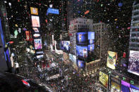 <p>Confetti drops over the crowd as the clock strikes midnight during the New Year’s celebration in Times Square as seen from the Marriott Marquis in New York, Monday, Jan. 1, 2018. (Photo: Seth Wenig/AP) </p>