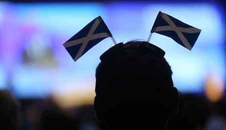 A delegate listens to a speech during the Scottish National Party's (SNP) Spring Conference in Glasgow, Scotland March 12, 2016. REUTERS/Russell Cheyne