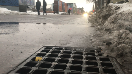 Rain and melting slush drain down Bank Street in Burlington on Thursday in the wake of Winter Storm Harper. Photographed  Jan. 24, 2019.