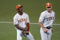 Texas' Trey Faltine (0) and Mitchell Daly (19) celebrate after turning a double play against South Florida to end the eighth inning in an NCAA Super Regional college baseball game, Sunday, June 13, 2021, in Austin, Texas. (AP Photo/Eric Gay)