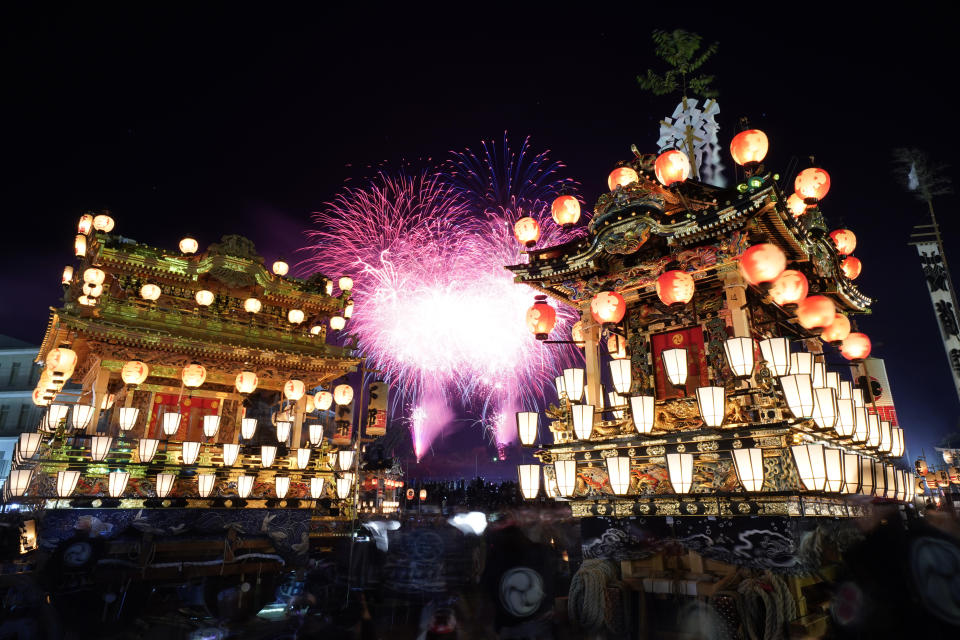 In this Tuesday, Dec. 3, 2019, photo, lantern-covered floats stand as fireworks light up the sky during the Chichibu Night Festival in Chichibu, north of Tokyo, Japan. The Chichibu Night Festival, which has roots that go back more than 1,000 years, is one of three famous Japanese festivals to feature huge floats, which can top 7 meters (23 feet) and weigh up to 15 tons. (AP Photo/Toru Hanai)