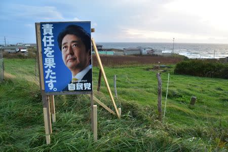 A poster showing face of Japan's Prime Minister Shinzo Abe, who is also ruling Liberal Democratic Party leader, is displayed in Erimo Town, on Japan's northern island of Hokkaido, October 12, 2017. Picture taken October 12, 2017. REUTERS/Malcolm Foster