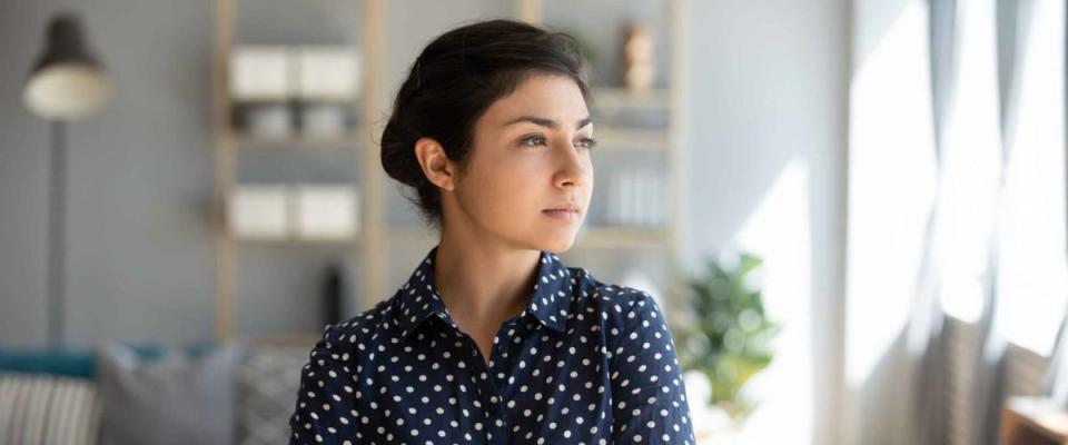 Serious confident young indian professional looks away