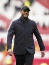 Burnley's head coach Vincent Kompany smiles after the English Premier League soccer match between Manchester United and Burnley at Old Trafford, Manchester, England, Saturday, April 27, 2024. (Martin Rickett/PA via AP)