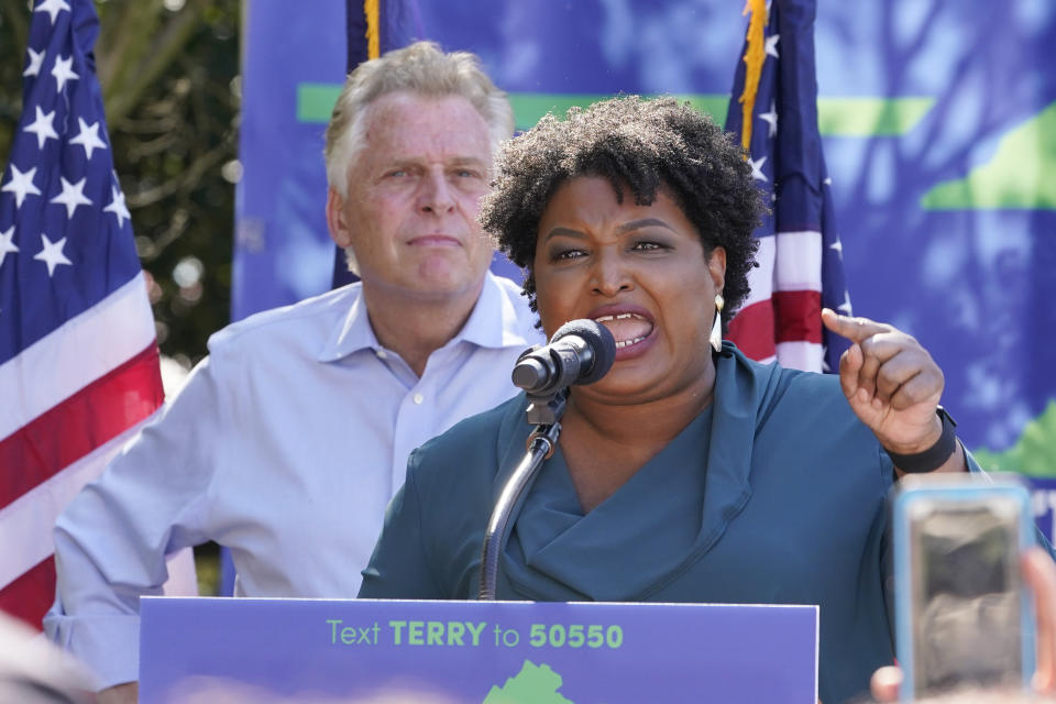 Voting rights activist Stacey Abrams, right, speaks during a rally with Democratic gubernatorial candidate, former Virginia Gov. Terry McAuliffe, left, in Norfolk, Va., Sunday, Oct. 17, 2021. Abrams was in town to encourage voters to vote for the Democratic gubernatorial candidate in the November election. (AP Photo/Steve Helber)