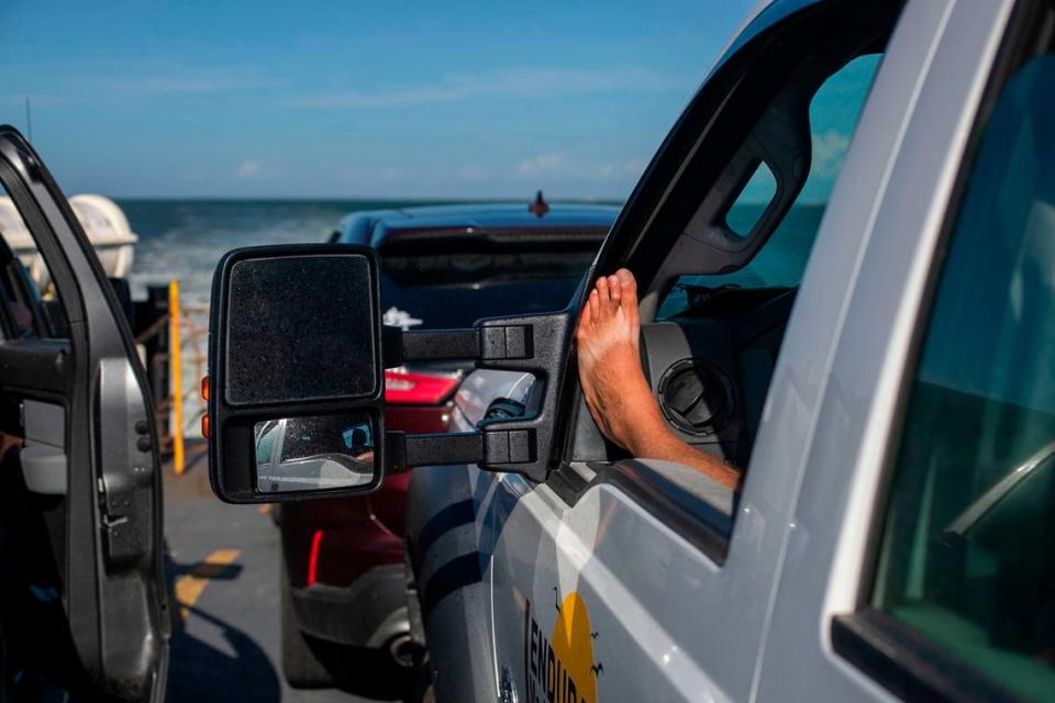 A passenger aboard the Cape Point Ferry shows their tan lines from a pair of flip flops during the trip from Hatteras to Ocracoke on Thursday, July 1, 2021.