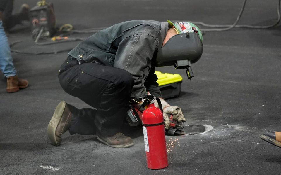 Work is performed on a manhole following the first practice session for the Formula One Las Vegas Grand Prix auto race, Thursday, Nov. 16, 2023, in Las Vega