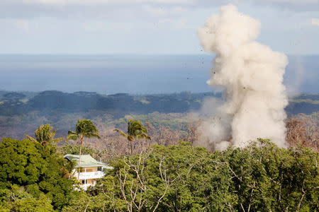 Smoke and lava erupt from a fissure near a home on the outskirts of Pahoa during ongoing eruptions of the Kilauea Volcano in Hawaii, U.S., May 14, 2018. REUTERS/Terray Sylvester TPX IMAGES OF THE DAY