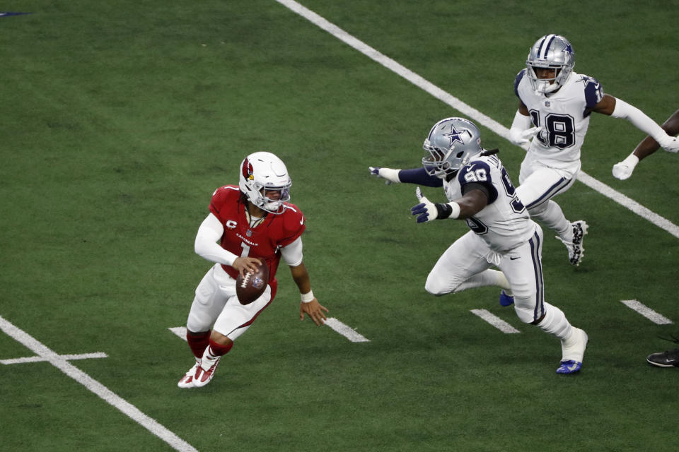 Arizona Cardinals quarterback Kyler Murray (1) escapes pressure from Dallas Cowboys defensive end Demarcus Lawrence (90) and free safety Damontae Kazee (18) during the first half of an NFL football game in Arlington, Texas, Sunday, Jan. 2, 2022. (AP Photo/Roger Steinman)