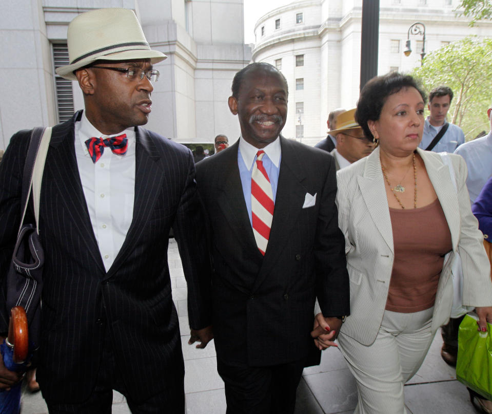 FILE - In this July 26, 2012, file photo, attorney Anthony Ricco, left, walks with Larry Seabrook, center, a New York City councilman and Seabrook's wife Maria Diaz, as they leave Federal Court in New York during Seabrook's corruption trial. It can be an uncomfortable life for any defense attorney representing unpopular clients, but when Ricco was among a handful of respected defense lawyers summoned to the federal courthouse in Manhattan after Sept. 11, he recalled his mother telling him, in a moment of outrage, "If you go down there to represent them, I will never speak to you again." (AP Photo/Richard Drew, File)
