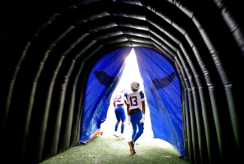 Millwood's Dylan Daniels (13) runs on to the field during the Class 2A state football championship between Millwood and Washington at Chad Richison Stadium in Edmond, Okla., Saturday, Dec.10, 2022. 