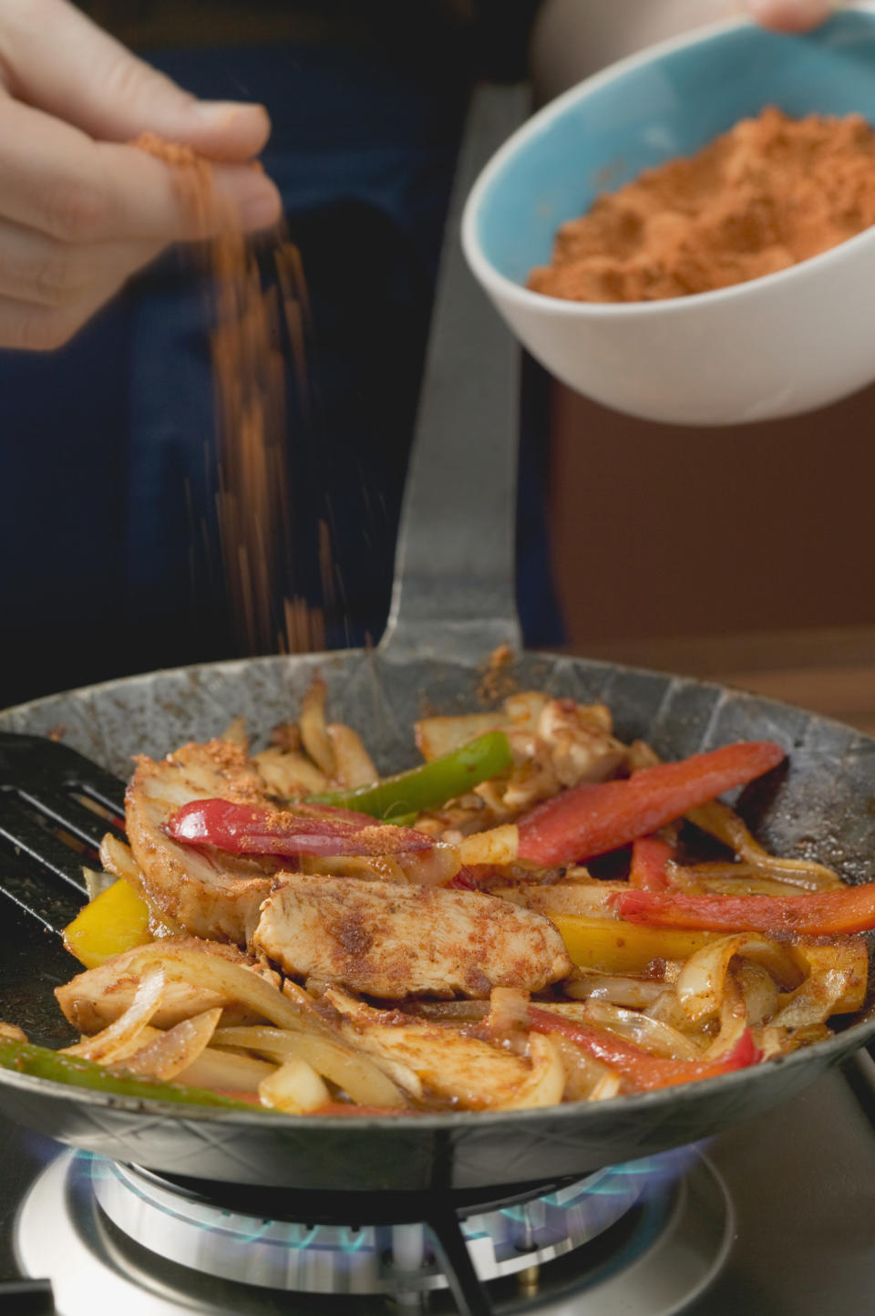 Seasoning fajitas on the stove