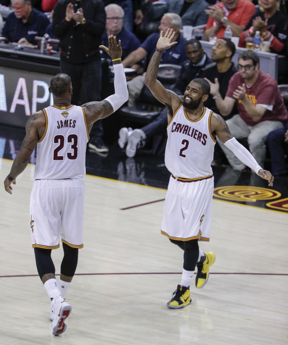Cleveland Cavaliers' LeBron James and Kyrie Irving high five