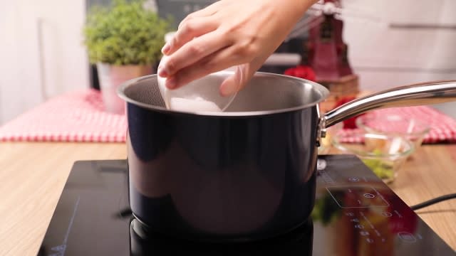 Pouring sugar into a pot