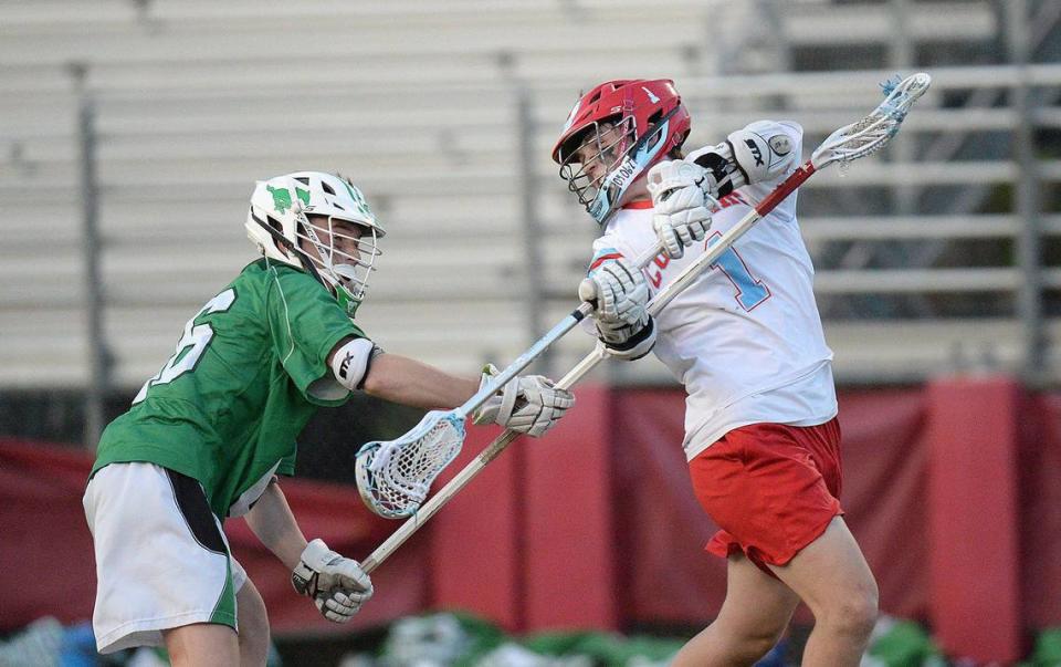 Charlotte Catholic’s #`1, Jack Ransom, scores a first half goal with an over-the-shoulder shot. Charlotte Catholic, ranked #1 in North Carolina and #3 nationally put a perfect, 13-0 record, on the line against 6-3 Myers Park for a match of boys lacrosse teams. The teams were tied 9-9 after the first half. Catholic’s Jack Ransom, a Georgetown recruit, is a standout player. The teams battled on Monday, April 8, 2024. John D. Simmons/Special to the Observer