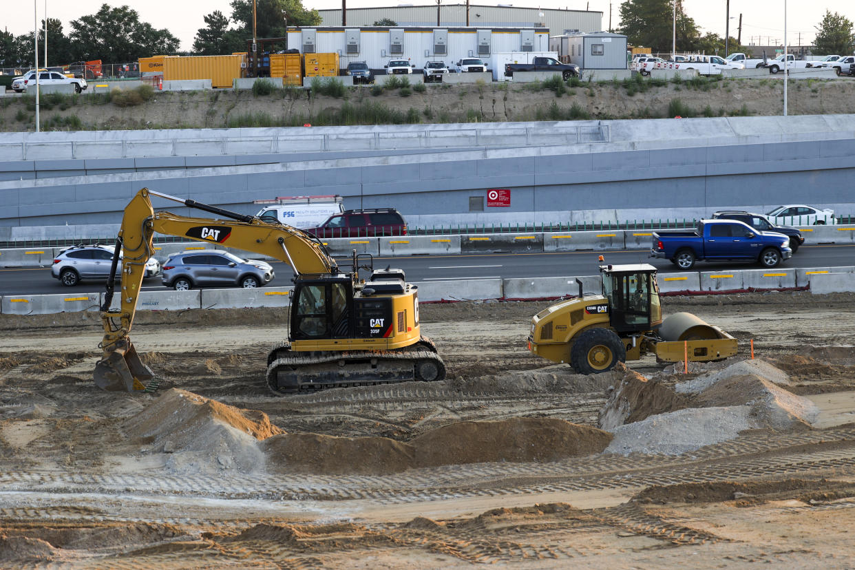 A construction crew works at a site for the Colorado Central 70 project at Interstate 70 in Denver, on Thursday.