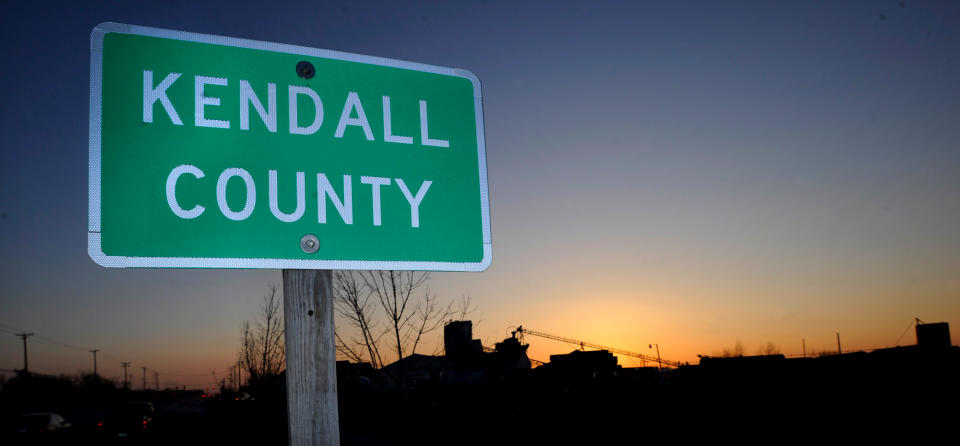 FILE - This March 19, 2008, file photo shows a Kendall County street sign in Oswego, Ill., about 50 miles west of Chicago. The nation's No. 1 fastest-growing county from 2000 to 2010, Kendall was part of an exurban wave in the heady 2000s that more than doubled Kendall's population. Now Census estimates as of July 2011 highlight a shift in population trends, following an extended housing bust and renewed spike in oil prices; outlying suburbs are now seeing their growth fizzle to historic lows, halting American city dwellers' decades-long exodus to sprawling homes in distant towns. (AP Photo/Paul Beaty, File)