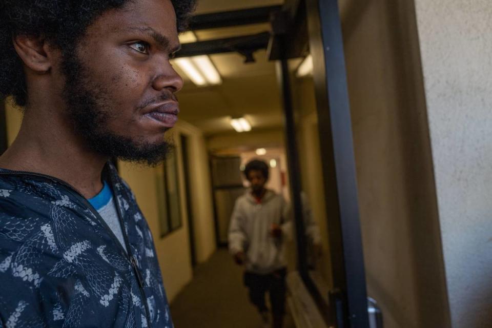 Project Roomkey participant Benjamin Frazier, 26, stands in the hallway at the Vagabond Inn on Wednesday. His room is on the third floor and the elevator is broken, and no fix is promised.