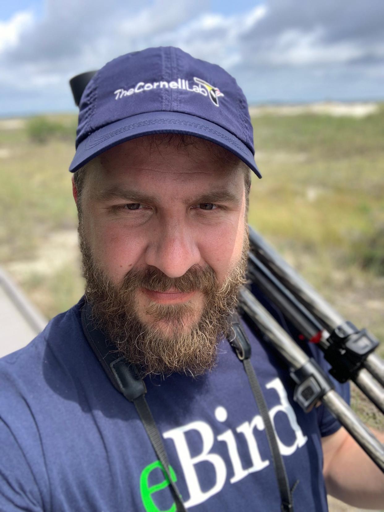 Goshen College grad Drew Weber, who works as project manager for the Merlin Bird ID App, looks for birds in Lost Maples State Natural Area in Texas.