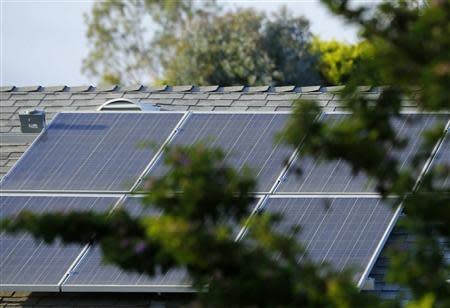 A home with solar panels on its roof is shown in a residential neighborhood in San Marcos, California September 19, 2013. REUTERS/Mike Blake