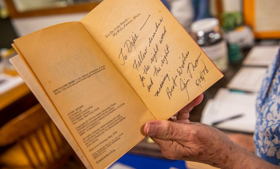 Dixie Richardson shows her autographed copy of one of James Alexander Thom's books at the 10 O'clock Line Treaty Museum in Gosport on Friday, April 14, 2023.
