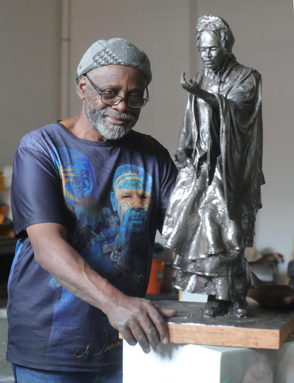 International sculptor Woodrow Nash with a small scale model of the Sojourner Truth statue on Wednesday, May 19, 2021 in Akron, Ohio.  [Phil Masturzo/ Beacon Journal]