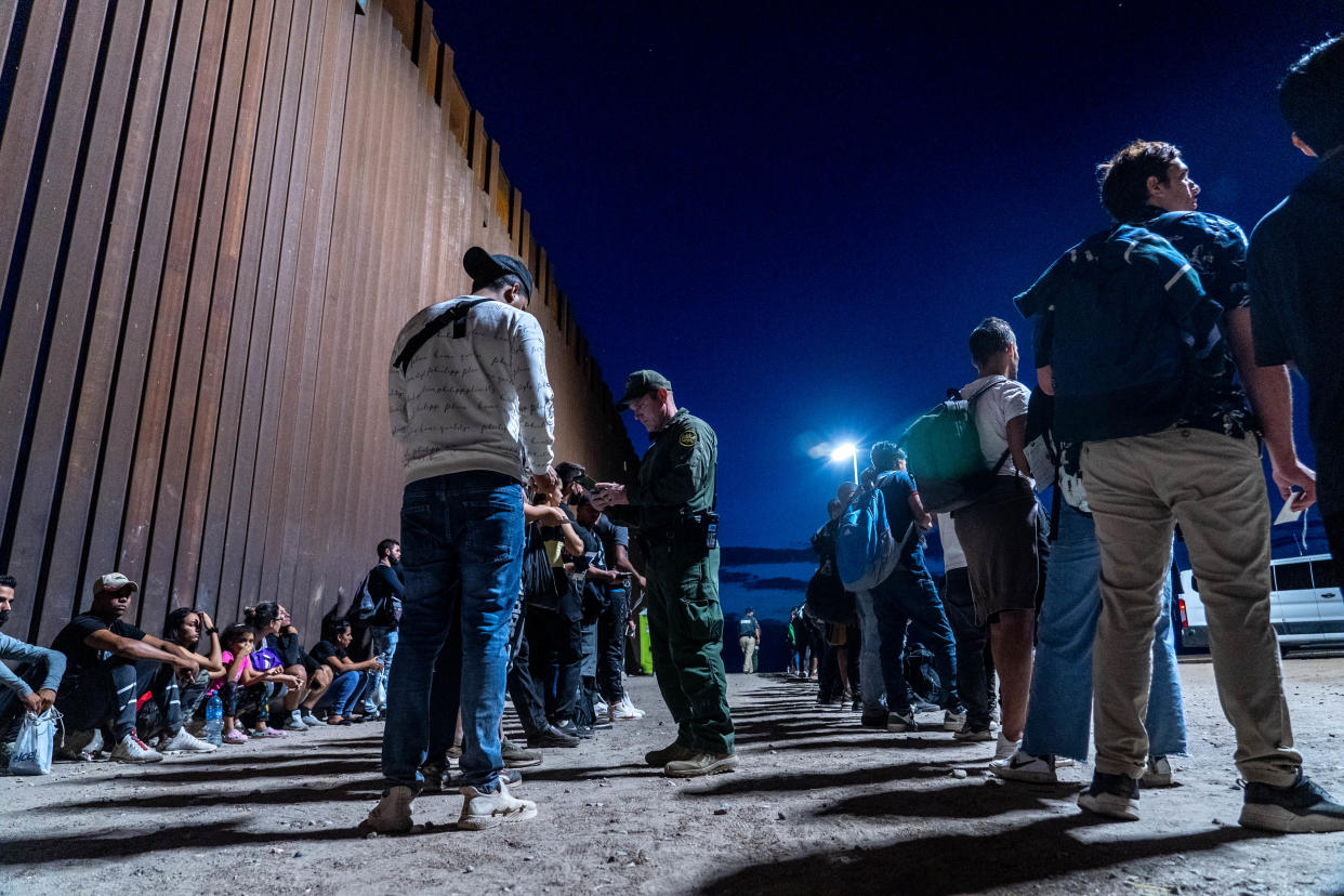 Migrants and asylum seekers are detained by U.S. Border Patrol agents after crossing the U.S.-Mexico border in Yuma County, Arizona, near the Cocopah Indian Tribe’s reservation on July 28, 2022.