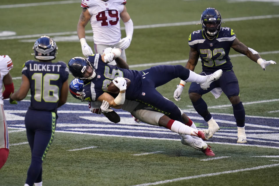 Seattle Seahawks tight end Jacob Hollister (86) is brought down by New York Giants linebacker Tae Crowder (48) during the second half of an NFL football game, Sunday, Dec. 6, 2020, in Seattle. (AP Photo/Elaine Thompson)